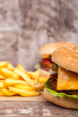 Home made Delicious tasty burgers on wooden background. Fast and tasty food