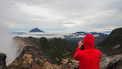Fototapeta na wymiar Freedom man standing on top of Mount Sibayak, Indonesia
