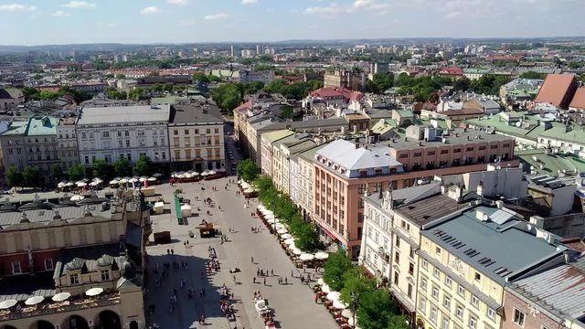 undefined people walking on the Market Square (Rynek Glowny) It is a biggest square measuring 200 meters on the side, and is the largest medieval square in Europe.