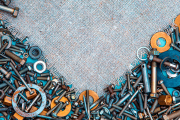 Abstract grunge metallic background from bolts, screws, nuts