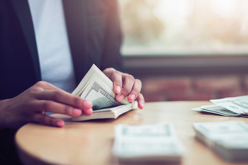 Businessman counting U.S. dollar bills.