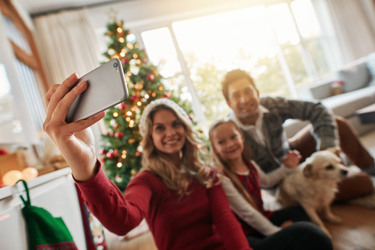 Young family talking selfie during Christmas at home