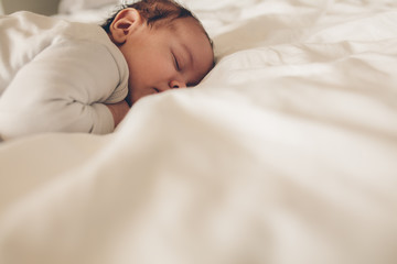 Little boy sleeping peacefully in bed