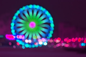 Defocused ferris wheel with colorful lights - Powered by Adobe