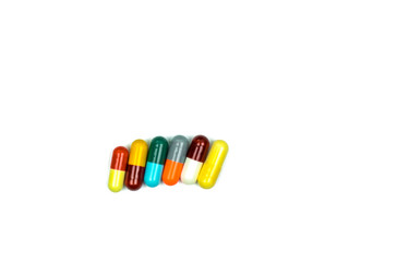 Colorful of antibiotic capsules pills in a row isolated on white background with clipping path. Drug resistance, antibiotic drug use with reasonable, health policy and health insurance concept.