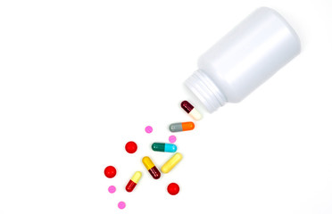 Antibiotic capsules spilling out of pill bottle isolated on white background with clipping path. Antibiotic drug use with reasonable concept. Health policy and health insurance concept