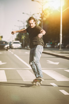 Pro skateboarder ride skateboard on capital road street through traffic