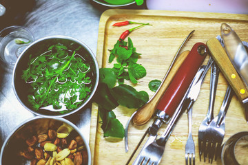 Coriander nut and herb, butcher's knife and forks on the kitchen table