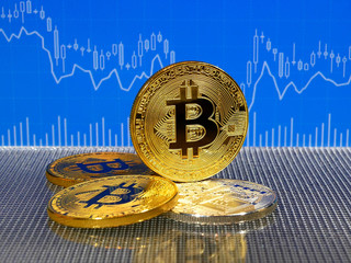 Golden and silver bitcoin coins on blue abstract finance background. Bitcoin cryptocurrency.