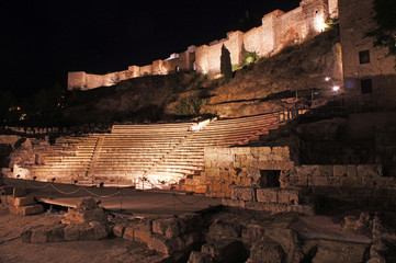 Night view on the roman theater Alcazaba and hill with castle (castillo de Gibralfaro) in Malaga, Spain