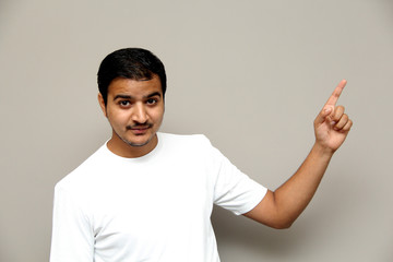 expressions of young amazed man isolated on gray background