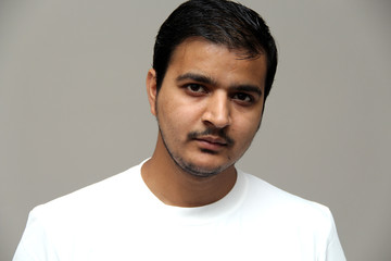 expressions of young amazed man isolated on gray background