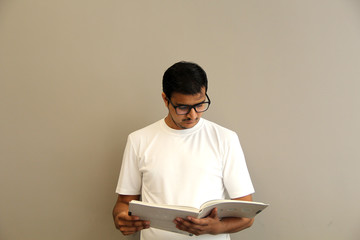 expressions of young amazed man isolated on gray background