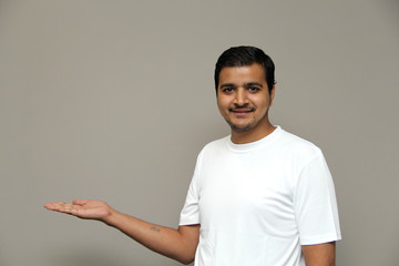 expressions of young amazed man isolated on gray background