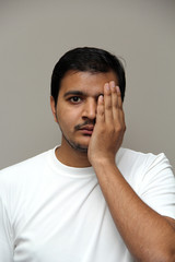 expressions of young amazed man isolated on gray background