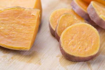 Cooked sliced and halved sweet potatoes on the table. Closeup.