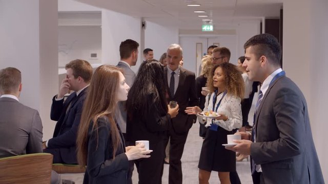 Delegates Networking During Coffee Break At Conference
