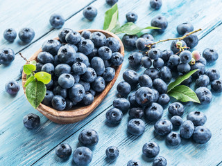 Blueberries in the wooden bowl on the table.