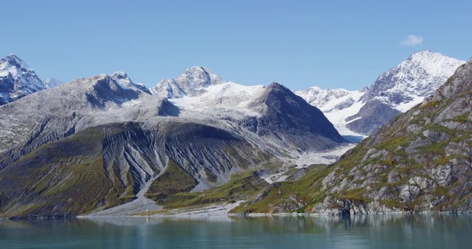 Glacier Bay National Park, Alaska, USA. Amazing glacial landscape showing mountain peaks and glaciers on clear blue sky summer day. RED EPIC SLOW MOTION.