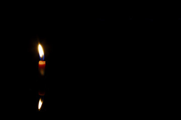 Little candle on a dark