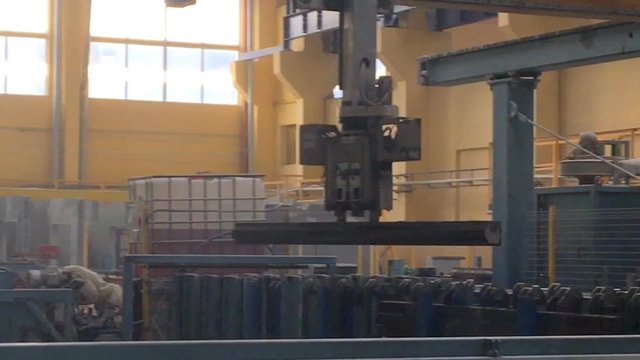The automated robot moves steel products.