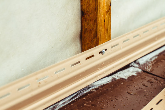 installation of siding on the facade of the house