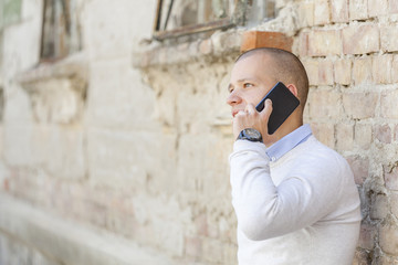 Obraz na płótnie Canvas He talks to his business partners via a cell phone