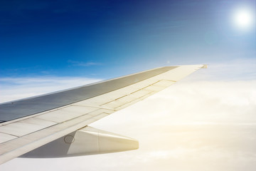 Looking through window aircraft during flight in wing with a nice blue sky