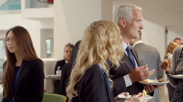 Delegates Networking During Coffee Break At Conference