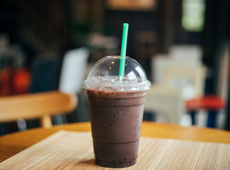 Cold iced coffee on wooden background.