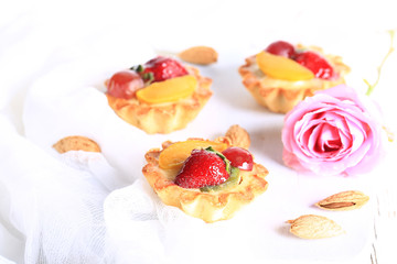 almond cake with strawberries on a white background selective soft focus