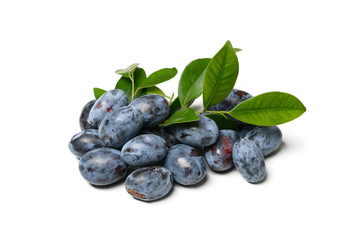 pile of plums with leaf isolated on a white background