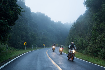 Motorcycle on foggy road in mystery land