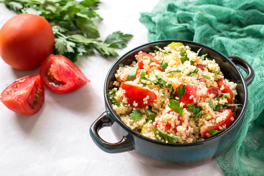 Bowl with couscous, vegetables and herbs