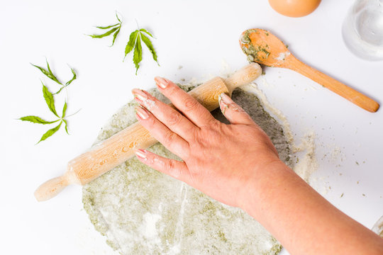 Woman kneading dough of marijuana and wheat flour