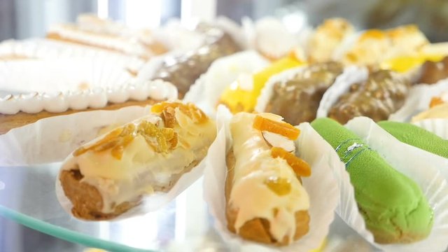 sweet eclairs on transparent plate