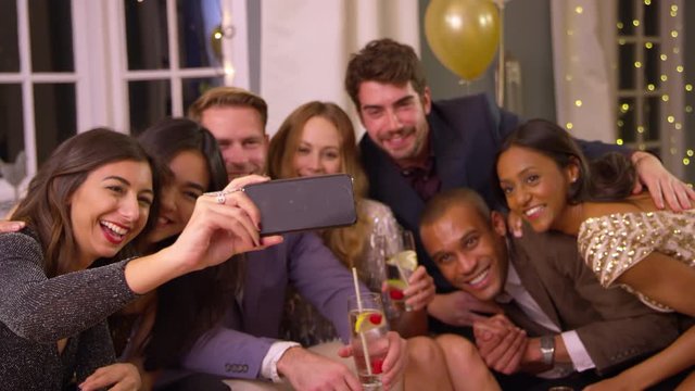 Friends Posing For Photo As They Celebrate At Party Together
