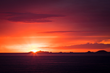 Iles Sanguinaires silhouetted against a dramatic orange sunset
