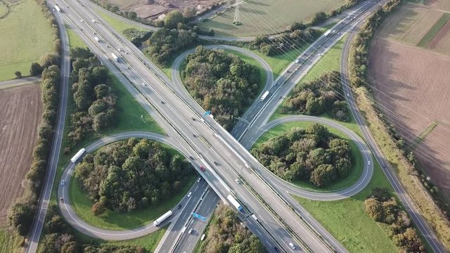 Aerial view of a highway intersection with a clover-leaf interchange