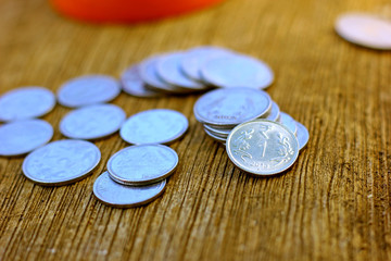 Indian coin on wooden texture ,