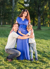 Fototapeta premium Happy pregnant family of three expecting new baby