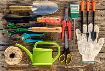 Gardening tools on wooden background flat lay