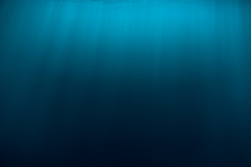 Water texture in underwater and sun rays. Blue ocean in underwater