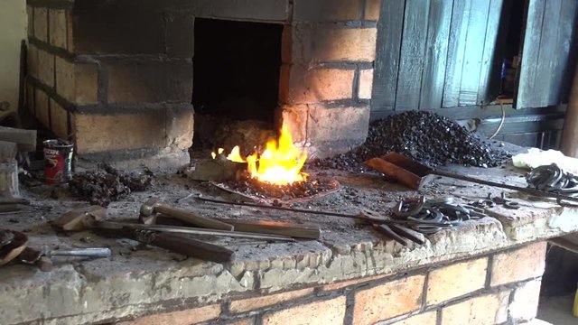 Panning blacksmith shop with burning fire