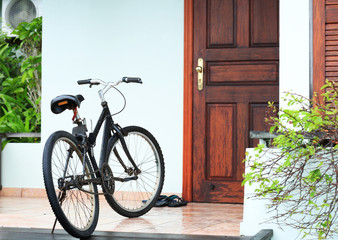 Fototapeta na wymiar Modern bicycle near house at resort