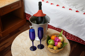Fruits and champagne in hotel room prepared for romantic date