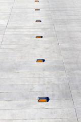 Direction, way - marble - granite path and cat's eyes; background, texture, pattern, copy space, signboard.