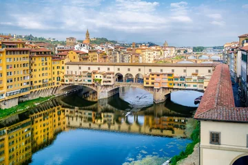 Fototapeten The city of Florence and the Ponte Vecchio, a medieval bridge over the river Arno © kmiragaya