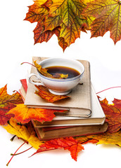 still life with autumn leaves, books and tea