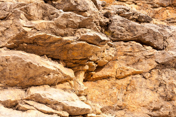 nature, canyon, trekking concept. on the ground that was transferred by wind and placed between cracks of this cliff there is small bunch of grass, that turned yellow because of ruthless sun